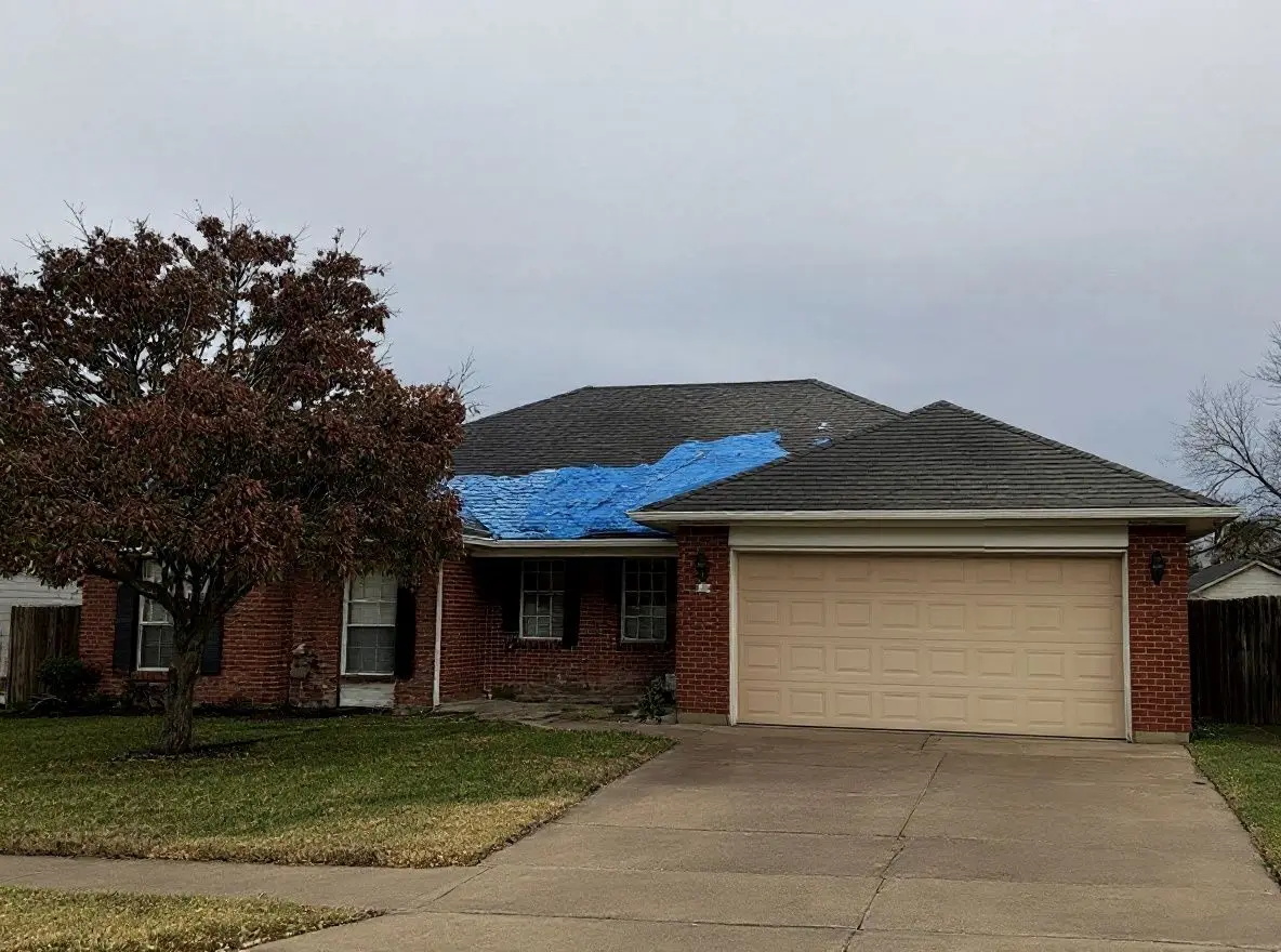 Before: a brick ranch house with a worn, hail-damaged roof and a blue tarp, under a grey sky